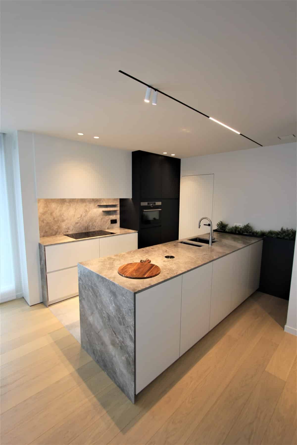 Witte keuken met een eiland in grijze natuursteen